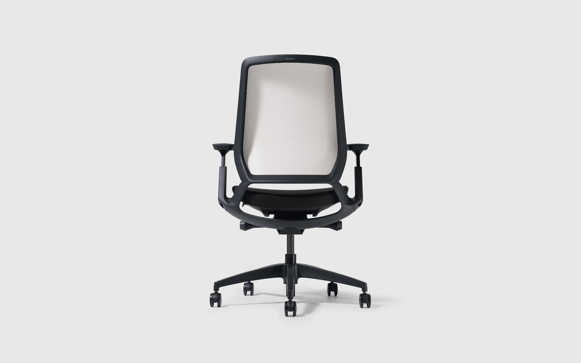 Back view of an Okamura Abilis office chair by ITO Design with a beige mesh backrest and black frame.