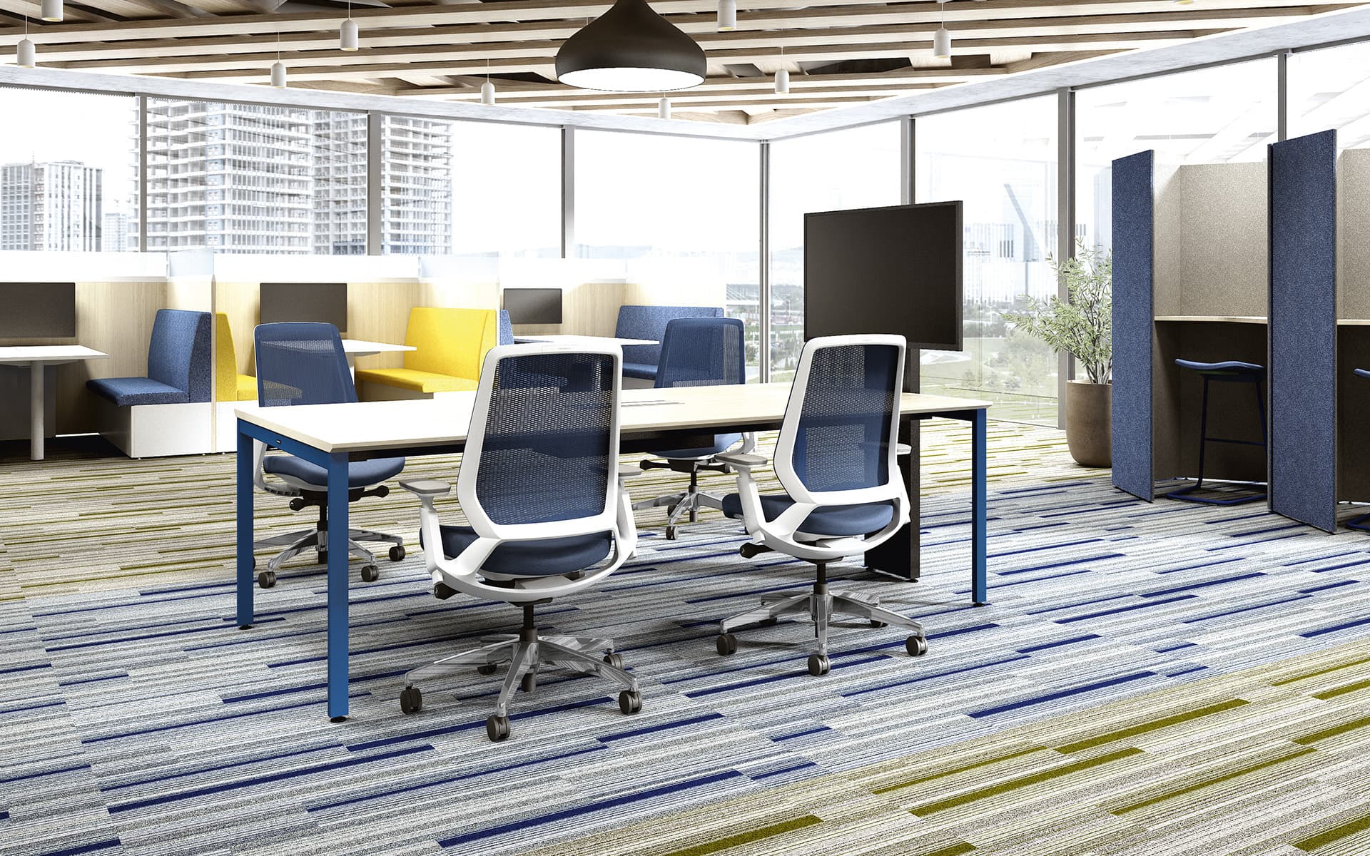 Four Okamura Abilis office chairs with dark blue mesh upholstery and backrest and white frame at a desk in a multifunctional working space with a big glass façade.